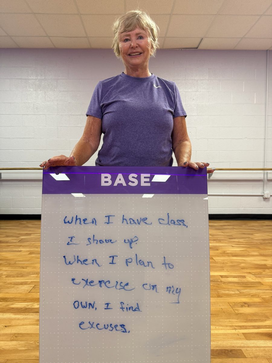 Ageless Fitness member holding a whiteboard sharing what they’re getting stronger for