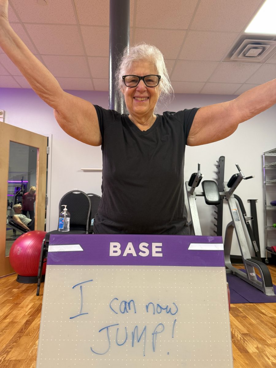 Ageless Fitness member holding a whiteboard sharing what they’re getting stronger for